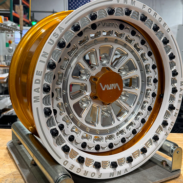 VNM Forged V-7 beadlock UTV wheels for the Maverick R 6 Lug 6x5.5 in prismatic powders flaming gold with white beadlock ring accent side by side off road buggy wheels