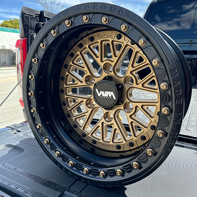 2023 2024 Can-Am Maverick R UTV wheels by VNM Forged in black satin with gold floating wheel caps, designed for dirt and sand tires. 15x8 and 15x10 off-road wheels with 6x5.5 6 lug pattern